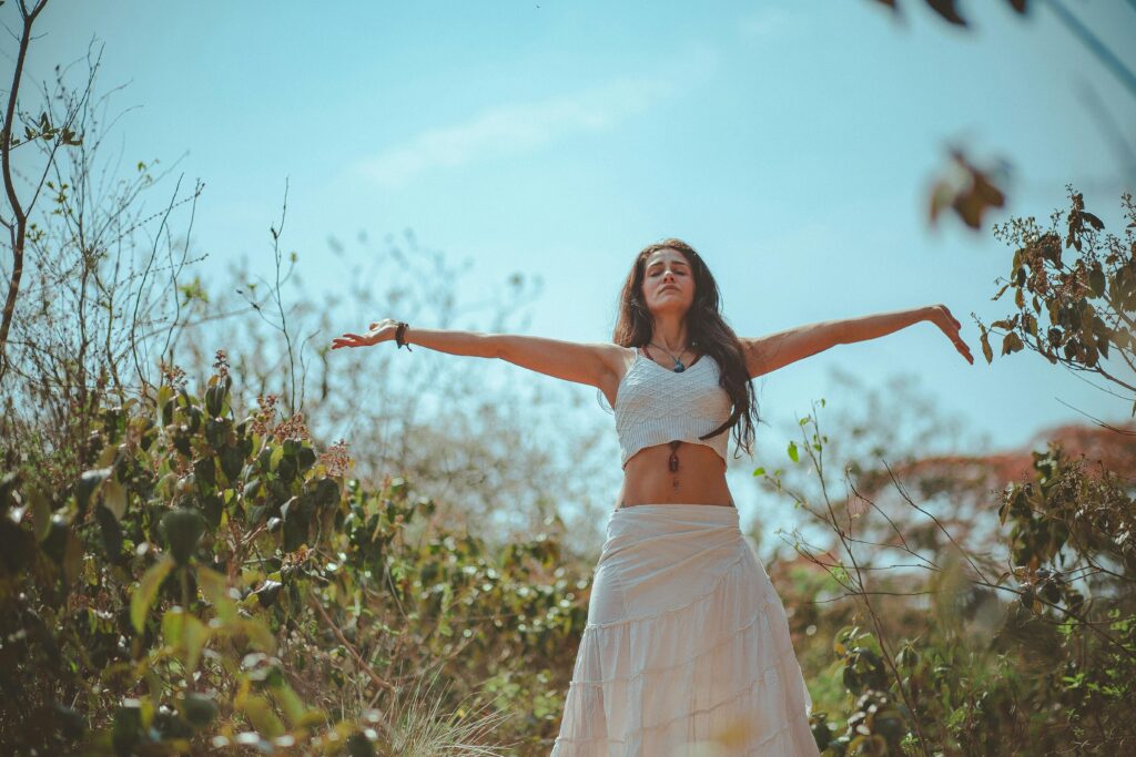 Peaceful scene of a woman meditating outdoors in a sunny summer setting, embodying wellness and tranquility. Lymph Savior Review: